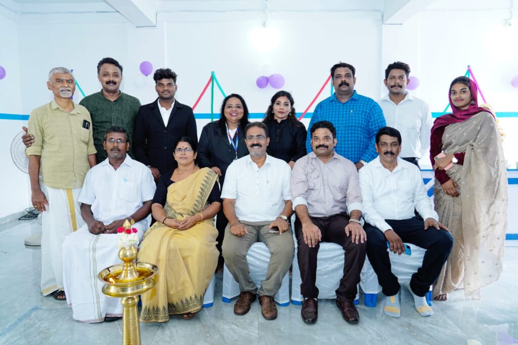 Kshemakrishi team members gathered for the inauguration of the new Palakkad branch office, posing with a traditional lamp (nilavilakku) and balloon decorations.
